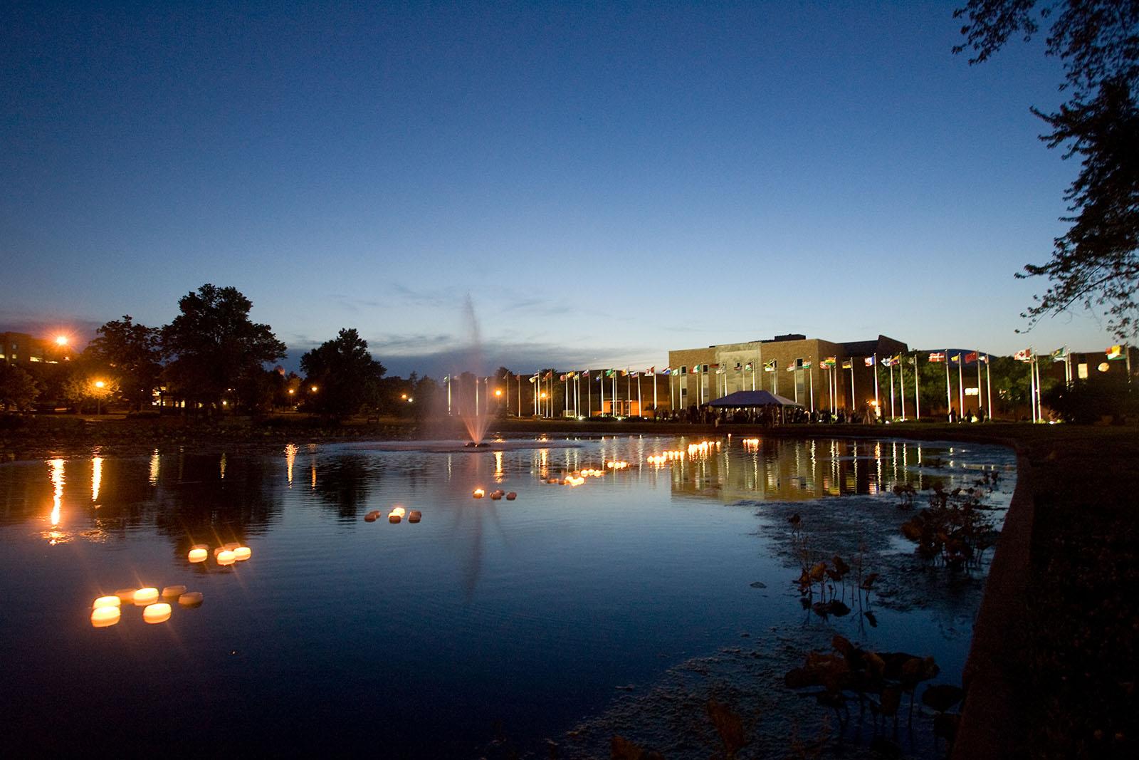 The International Plaza, seen here at night from across Colden Pond, was completed entirely through $400,000 in donations, with the most generous donation from Joyce and Harvey White, a couple with long-standing ties to Northwest.