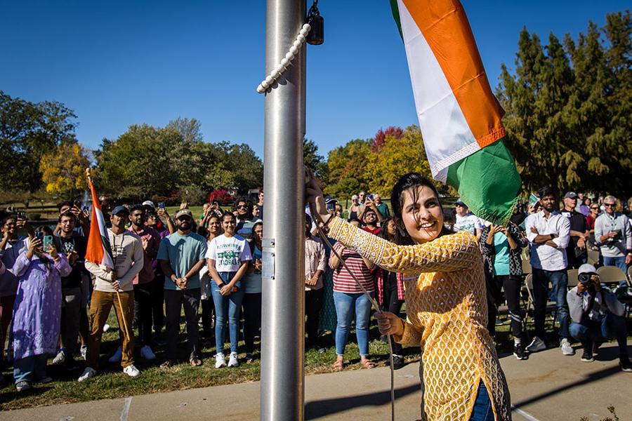 A student from India raises her native country's flag during Northwest's annual International Flag-Raising Ceremony, which celebrates the University's international students and diversity each fall. (Photo by Lauren Adams/Northwest Missouri State University) 